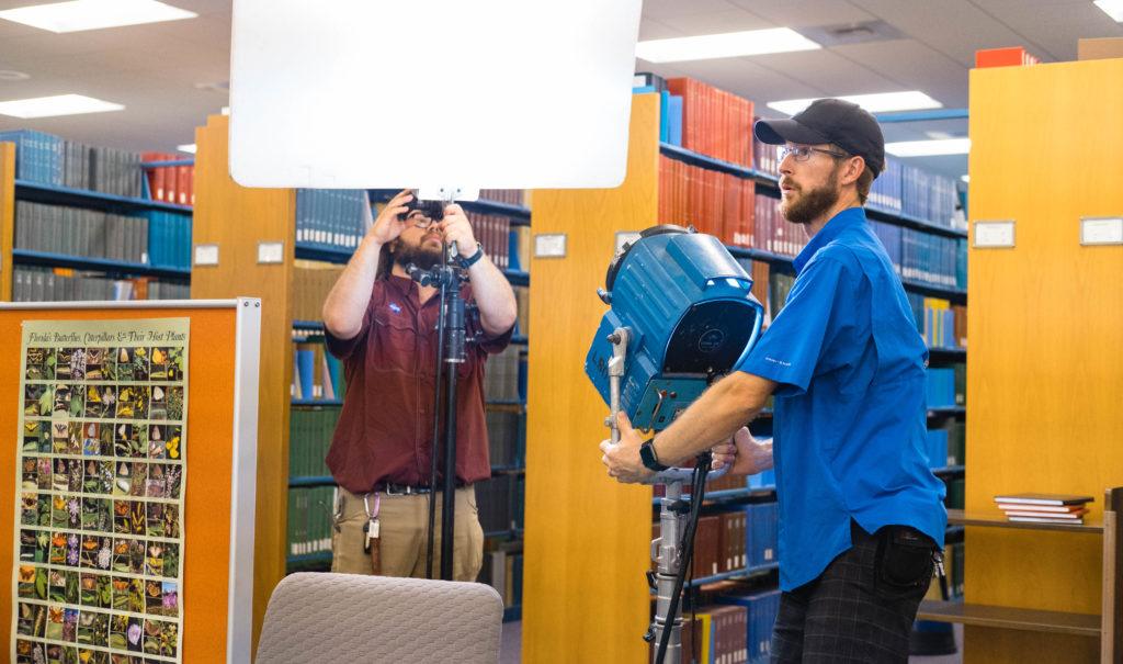 Lighting crew preparing for the next shot in the New College of Florida tour. 