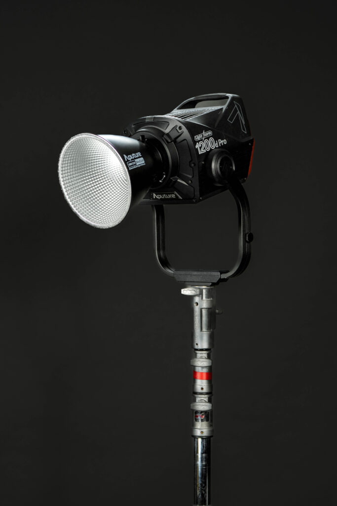 Aputure 1200d Pro daylight LED light set up outdoors on a heavy-duty stand.