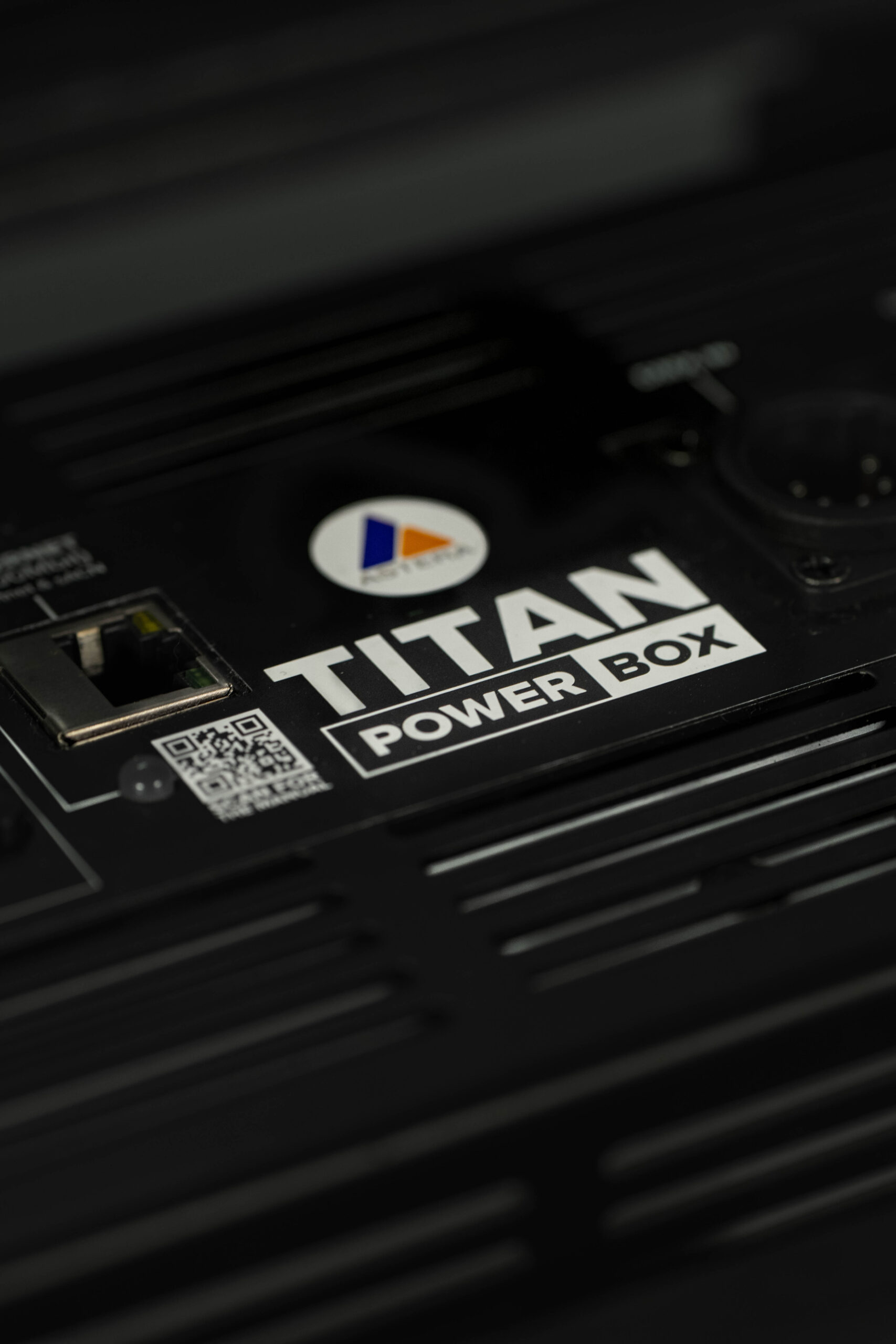 Astera Titan Tubes mounted on set in colored lighting configuration.